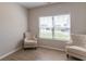 Bright living room featuring two chairs, wood floor, and a large window at 7144 Hart St, Cumberland, IN 46229