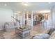 Open-concept living room with a view of the kitchen, stylish furniture, and hardwood floors at 7144 Hart St, Cumberland, IN 46229
