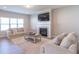 Bright living room features a fireplace, plush sofas, and a neutral color palette at 7144 Hart St, Cumberland, IN 46229