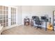 Modern home office with french doors, desk, guitars, and open bar decor at 7144 Hart St, Cumberland, IN 46229