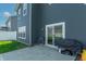Cozy outdoor patio with sliding glass door and a charcoal grill, ideal for relaxing and dining at 7144 Hart St, Cumberland, IN 46229