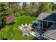 Aerial view of the backyard with a fire pit, pool, and manicured lawn at 7602 N Pennsylvania St, Indianapolis, IN 46240