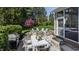 Landscaped backyard with patio dining, grill, circular firepit, swim spa and covered porch at 7602 N Pennsylvania St, Indianapolis, IN 46240