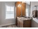 Bathroom vanity with granite countertop, wooden cabinets, and a large mirror at 7602 N Pennsylvania St, Indianapolis, IN 46240