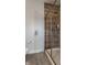 Modern bathroom featuring wood-style tile shower, glass door, and gray walls at 7602 N Pennsylvania St, Indianapolis, IN 46240