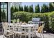 Outdoor dining area with table, chairs, grill and view of green space at 7602 N Pennsylvania St, Indianapolis, IN 46240