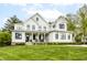 Stunning white modern farmhouse with a welcoming front porch and manicured lawn at 7602 N Pennsylvania St, Indianapolis, IN 46240