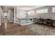 Hallway with hardwood floors, built-in bookshelves, and a view to a bedroom at 7602 N Pennsylvania St, Indianapolis, IN 46240