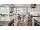 Kitchen with marble counters, stainless steel appliances, and hardwood floors that lead to the dining area at 7602 N Pennsylvania St, Indianapolis, IN 46240