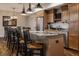 A gourmet kitchen features granite countertops, stainless steel appliances, and a breakfast bar with seating at 7602 N Pennsylvania St, Indianapolis, IN 46240
