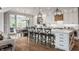 Beautiful kitchen with white cabinets, large island with chairs, and stainless steel appliances at 7602 N Pennsylvania St, Indianapolis, IN 46240