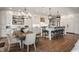 Spacious kitchen features a center island with bar seating, farmhouse sink, and an adjacent dining area at 7602 N Pennsylvania St, Indianapolis, IN 46240