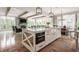 Modern kitchen with large island, stainless steel appliances, and an open layout to the living area at 7602 N Pennsylvania St, Indianapolis, IN 46240