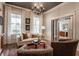 Bright living room with a black ceiling fixture, and a comfortable seating area at 7602 N Pennsylvania St, Indianapolis, IN 46240
