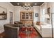 Inviting living room with red rug, plush chairs, and built-in wooden display cabinet at 7602 N Pennsylvania St, Indianapolis, IN 46240