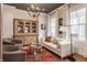 Comfortable living room with natural light, chandelier, and built-in cabinet at 7602 N Pennsylvania St, Indianapolis, IN 46240