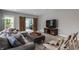 Living room with a large sectional, accent chairs, and a wooden media center at 7602 N Pennsylvania St, Indianapolis, IN 46240