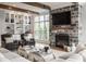 Comfortable living room with fireplace, built-in shelves, and large windows at 7602 N Pennsylvania St, Indianapolis, IN 46240