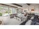 Open-concept living room with kitchen, dining area, and sliding glass doors to the backyard at 7602 N Pennsylvania St, Indianapolis, IN 46240