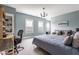 Spacious main bedroom with a king bed, sitting area, and built-in bookcase at 7602 N Pennsylvania St, Indianapolis, IN 46240