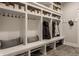 Mudroom with individual storage lockers, bench seating, and upper shelving at 7602 N Pennsylvania St, Indianapolis, IN 46240