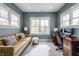 Comfortable home office featuring bright natural light, couch, desk and modern design at 7602 N Pennsylvania St, Indianapolis, IN 46240