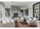 Covered patio featuring a stone fireplace, cozy seating, and stylish decor for outdoor enjoyment at 7602 N Pennsylvania St, Indianapolis, IN 46240
