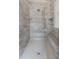 Large walk-in shower with rainfall shower head, bench, and tiled surround at 7602 N Pennsylvania St, Indianapolis, IN 46240