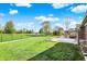 Large backyard with hot tub, lush green grass, and privacy fence at 7618 Ballyshannon St, Indianapolis, IN 46217