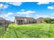 A lush backyard features a well-maintained lawn with a black chain-link fence at 7618 Ballyshannon St, Indianapolis, IN 46217