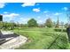 Lush backyard and neighborhood with black fencing and a manicured lawn at 7618 Ballyshannon St, Indianapolis, IN 46217