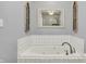 White jacuzzi style tub in a bathroom with tiled walls at 7618 Ballyshannon St, Indianapolis, IN 46217
