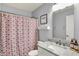 This bathroom features a single sink vanity with a marble countertop and a shower with a curtain at 7618 Ballyshannon St, Indianapolis, IN 46217
