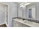 Bathroom featuring double sinks, decorative backsplash, and glass shower at 7618 Ballyshannon St, Indianapolis, IN 46217