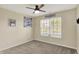 This bedroom features a ceiling fan, window with blinds, and a wall-mounted TV bracket at 7618 Ballyshannon St, Indianapolis, IN 46217