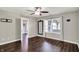 Bedroom with ceiling fan, wood floors, and window providing natural light at 7618 Ballyshannon St, Indianapolis, IN 46217