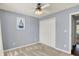 This bedroom features a ceiling fan, closet, window with blinds, and carpet at 7618 Ballyshannon St, Indianapolis, IN 46217