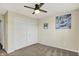 This bedroom features a ceiling fan, closet, window with blinds, and carpet at 7618 Ballyshannon St, Indianapolis, IN 46217