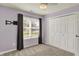 This bedroom features a ceiling fan, closet, window with blinds, and a wall-mounted TV bracket at 7618 Ballyshannon St, Indianapolis, IN 46217