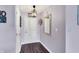 Entryway featuring wood floors, lavender colored walls, decorative lighting, and a stylish mirror at 7618 Ballyshannon St, Indianapolis, IN 46217