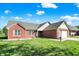 Charming red brick home with a well-maintained lawn and inviting curb appeal at 7618 Ballyshannon St, Indianapolis, IN 46217