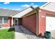 Inviting entryway featuring a red brick facade and landscaped walkway leading to the front door at 7618 Ballyshannon St, Indianapolis, IN 46217