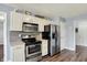 Kitchen boasting stainless steel appliances, white cabinetry, and a convenient pantry at 7618 Ballyshannon St, Indianapolis, IN 46217