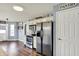 Kitchen featuring stainless steel appliances, a pantry, and access to the outdoor patio at 7618 Ballyshannon St, Indianapolis, IN 46217