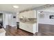 Spacious kitchen with white cabinets, stainless steel dishwasher and a view into the living area at 7618 Ballyshannon St, Indianapolis, IN 46217