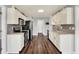 Well-lit kitchen featuring stainless steel appliances, white cabinets, and stylish backsplash at 7618 Ballyshannon St, Indianapolis, IN 46217