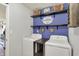 The laundry room has a washer and dryer, shelves, cabinets, and a sign at 7618 Ballyshannon St, Indianapolis, IN 46217