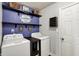The laundry room has a washer and dryer, shelves, cabinets, and a sign at 7618 Ballyshannon St, Indianapolis, IN 46217