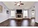 Spacious living room featuring a fireplace and natural light from surrounding windows at 7618 Ballyshannon St, Indianapolis, IN 46217