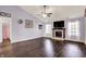 Spacious living room featuring a fireplace, ceiling fan, and natural light from surrounding windows at 7618 Ballyshannon St, Indianapolis, IN 46217
